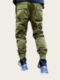 Green cargo pants worn by a person on a white background