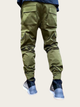 Green cargo pants worn by a person on a white background