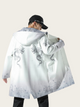 Person wearing a white coat with dragon designs on a plain background