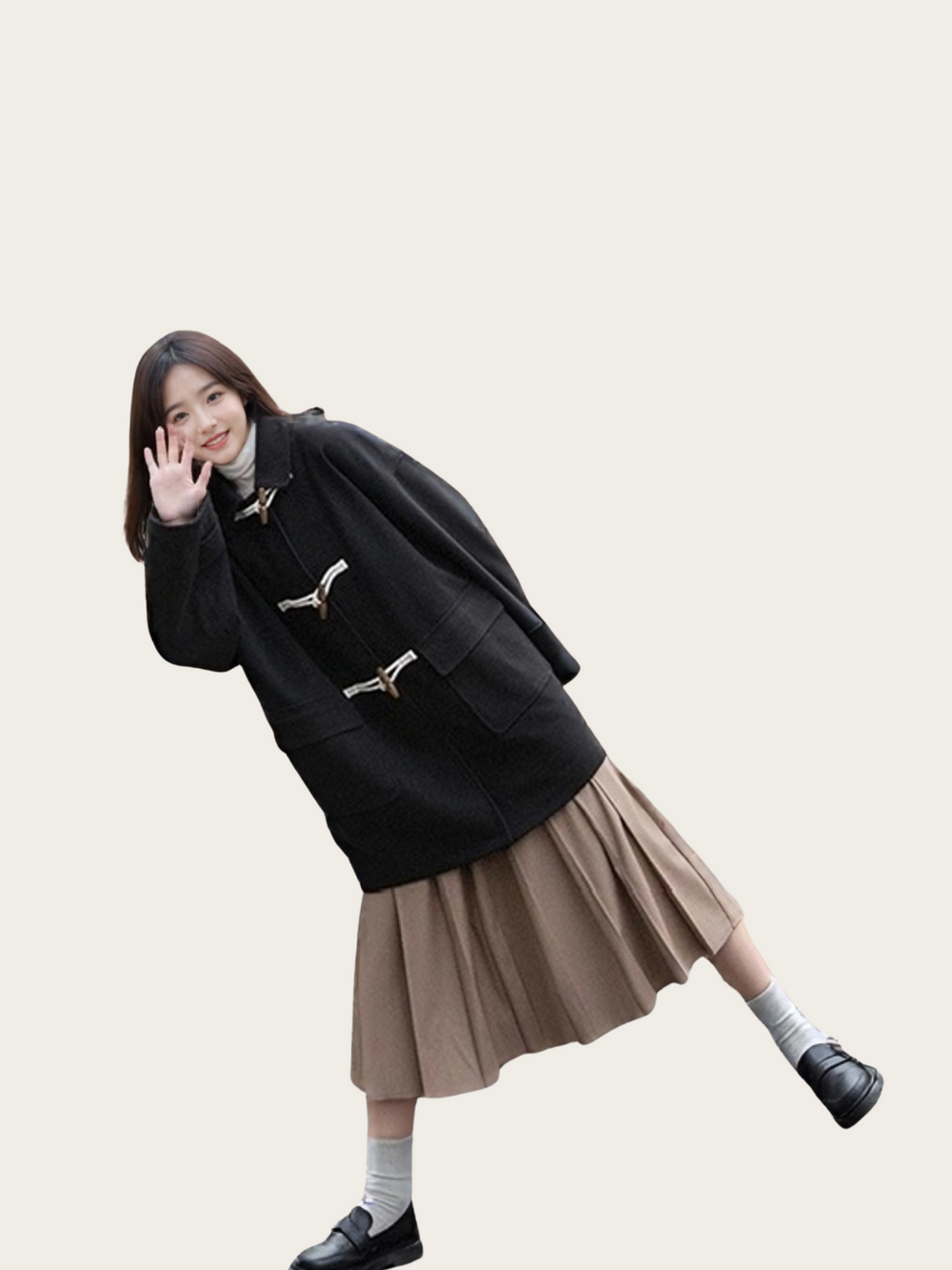 Person wearing a black coat and beige skirt on a plain background