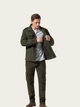 Man wearing a green jacket and pants on a white background