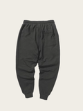 Dark gray sweatpants on a beige background