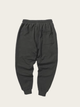 Dark gray sweatpants on a beige background