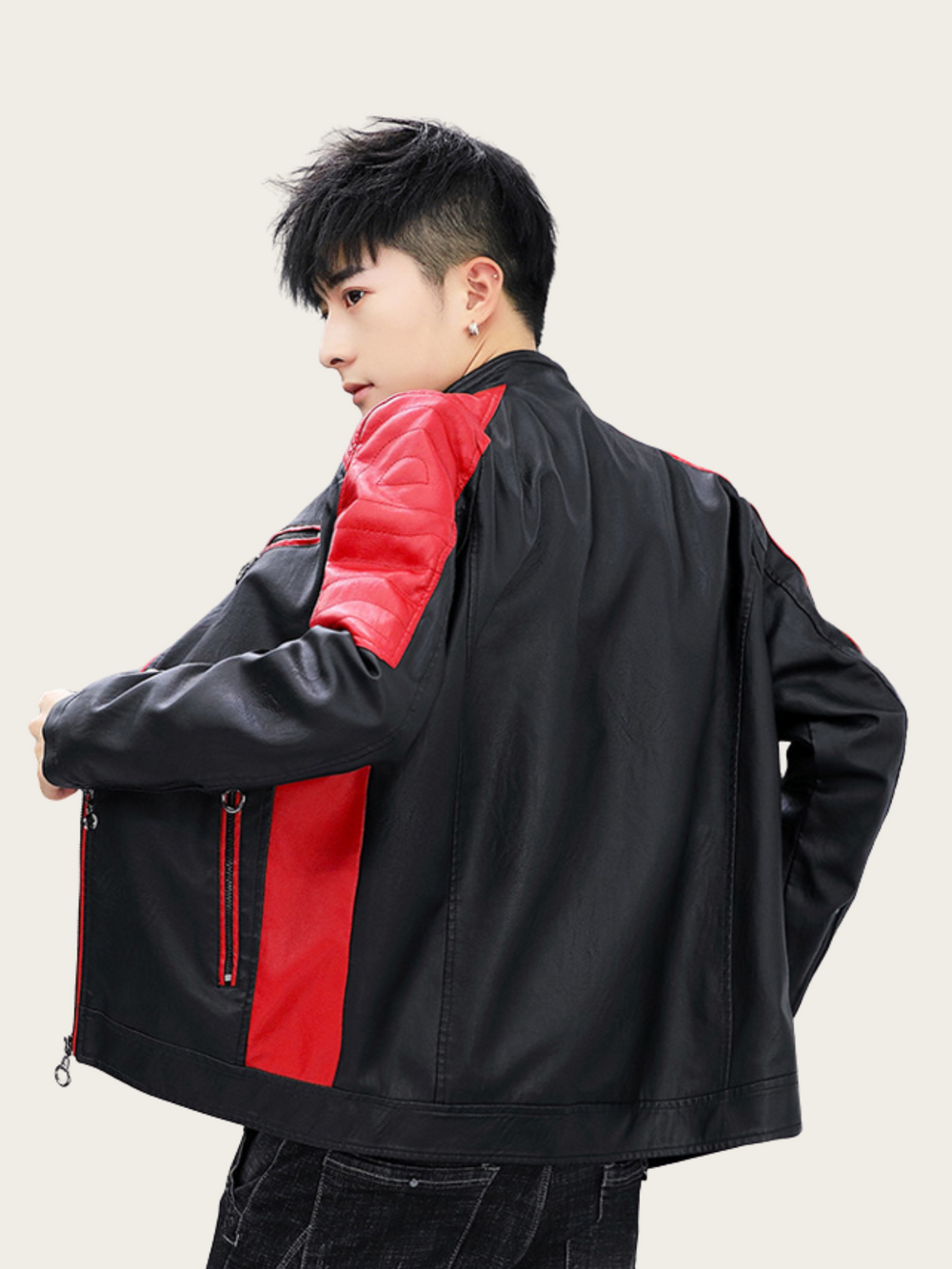 Person wearing a black and red jacket on a plain background