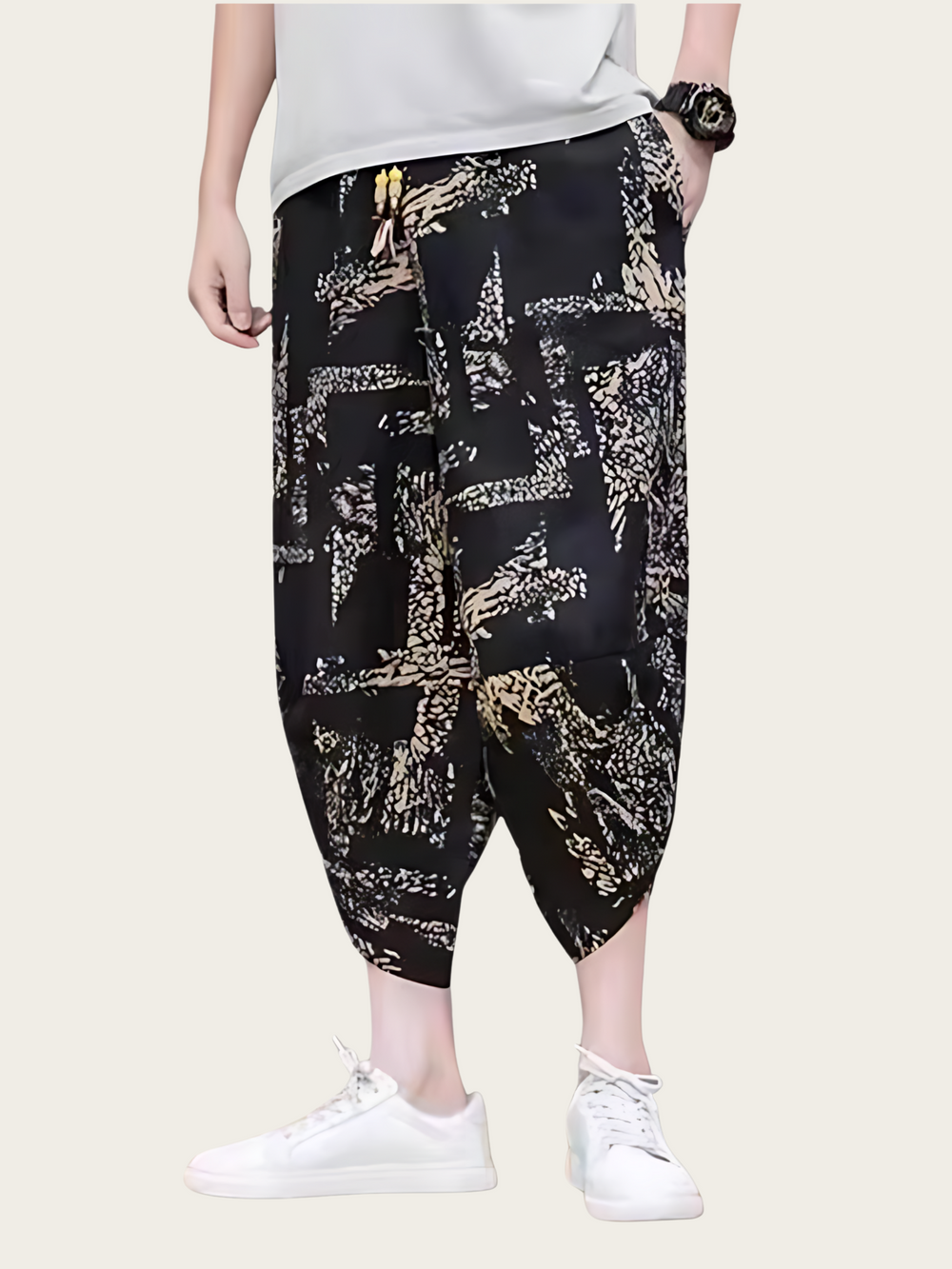 Person wearing black and gold patterned pants on a white background