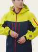 Person wearing a yellow and navy jacket with red accents on a white background