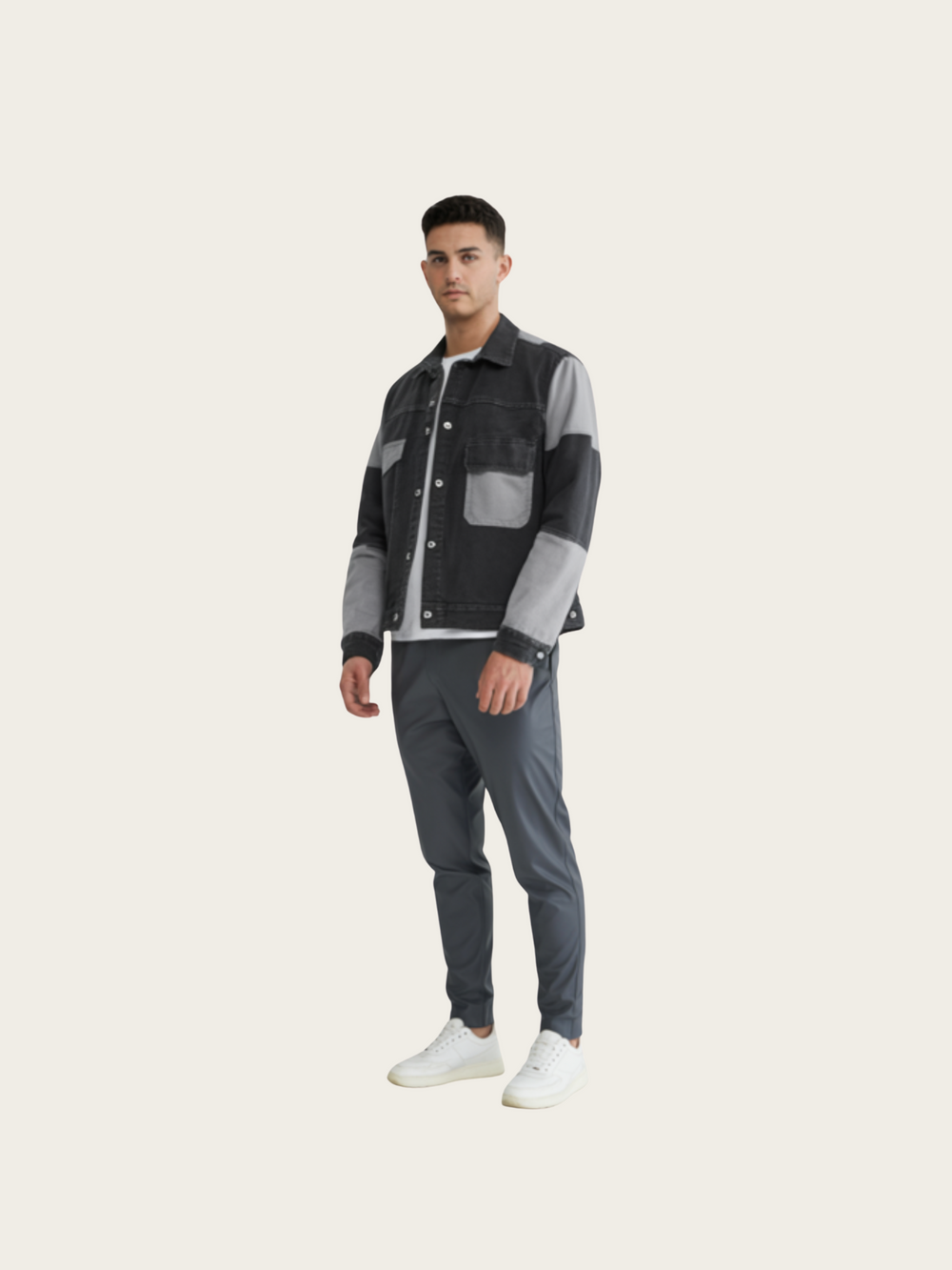 Man wearing a patterned jacket and gray pants on a white background