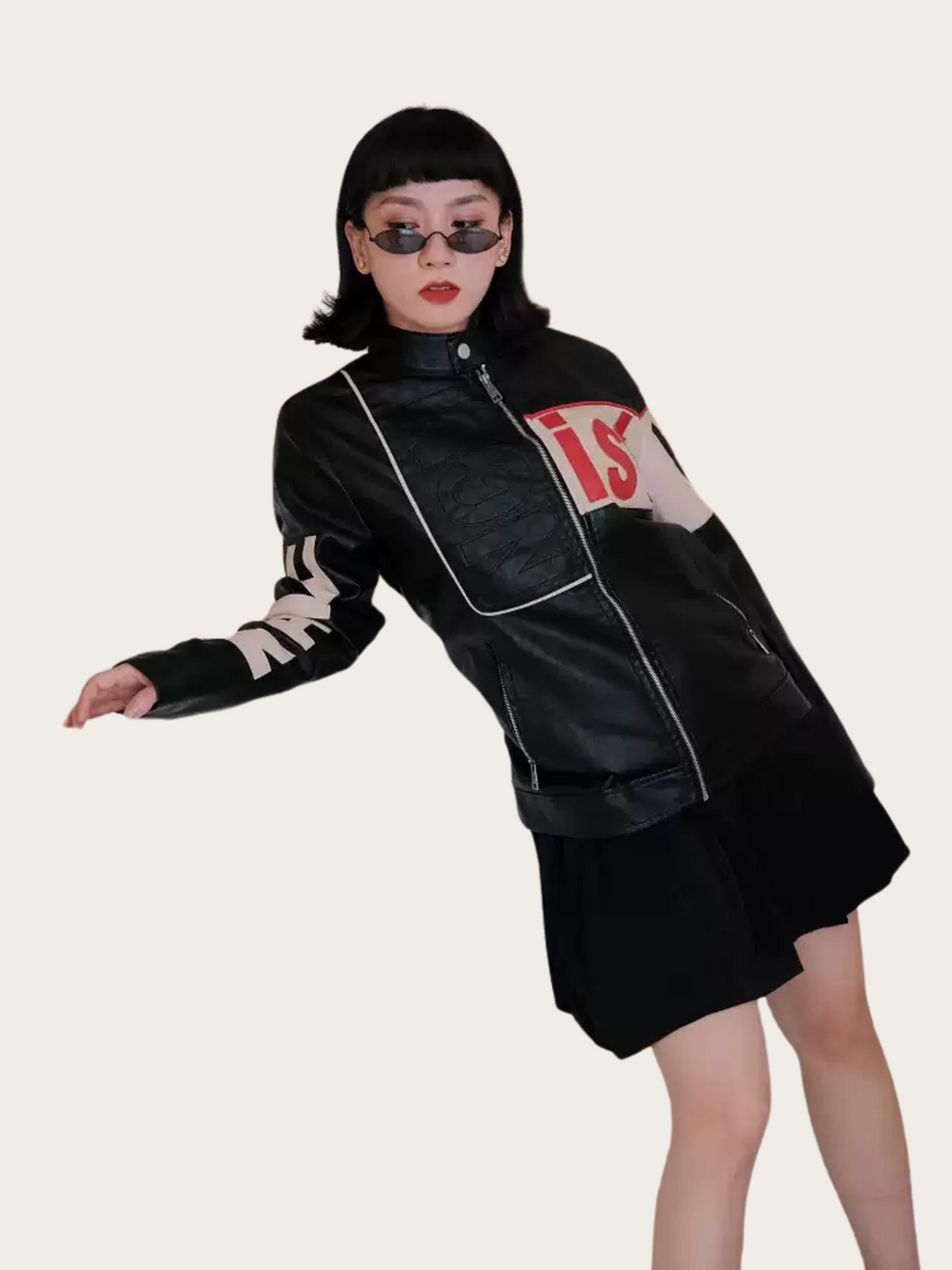 Person wearing a black leather jacket with white text on a plain background