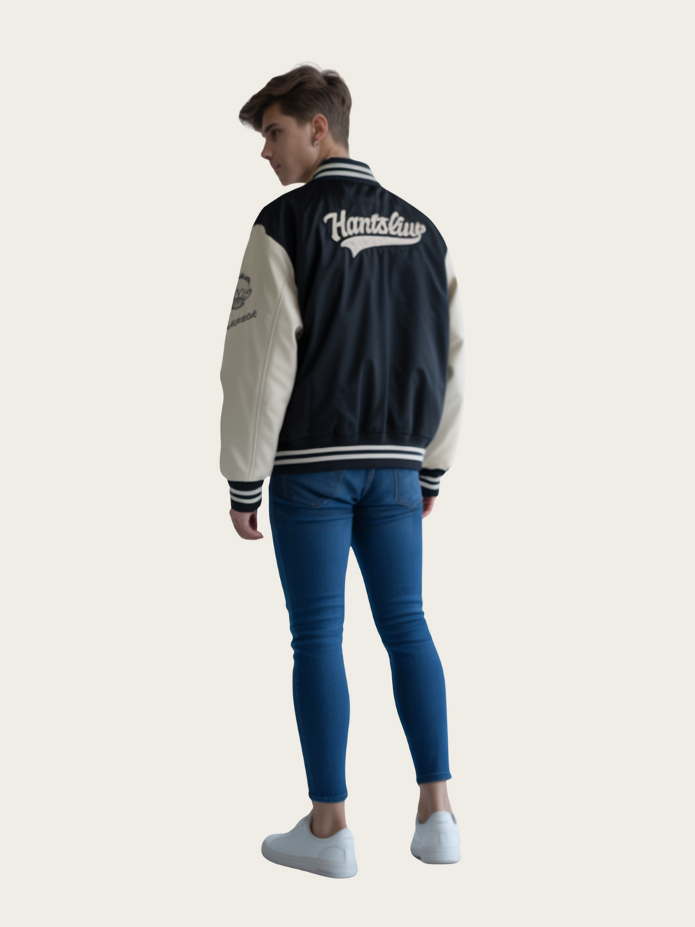 Person wearing a navy and white varsity jacket with 'Hansfield' branding on a light gray background