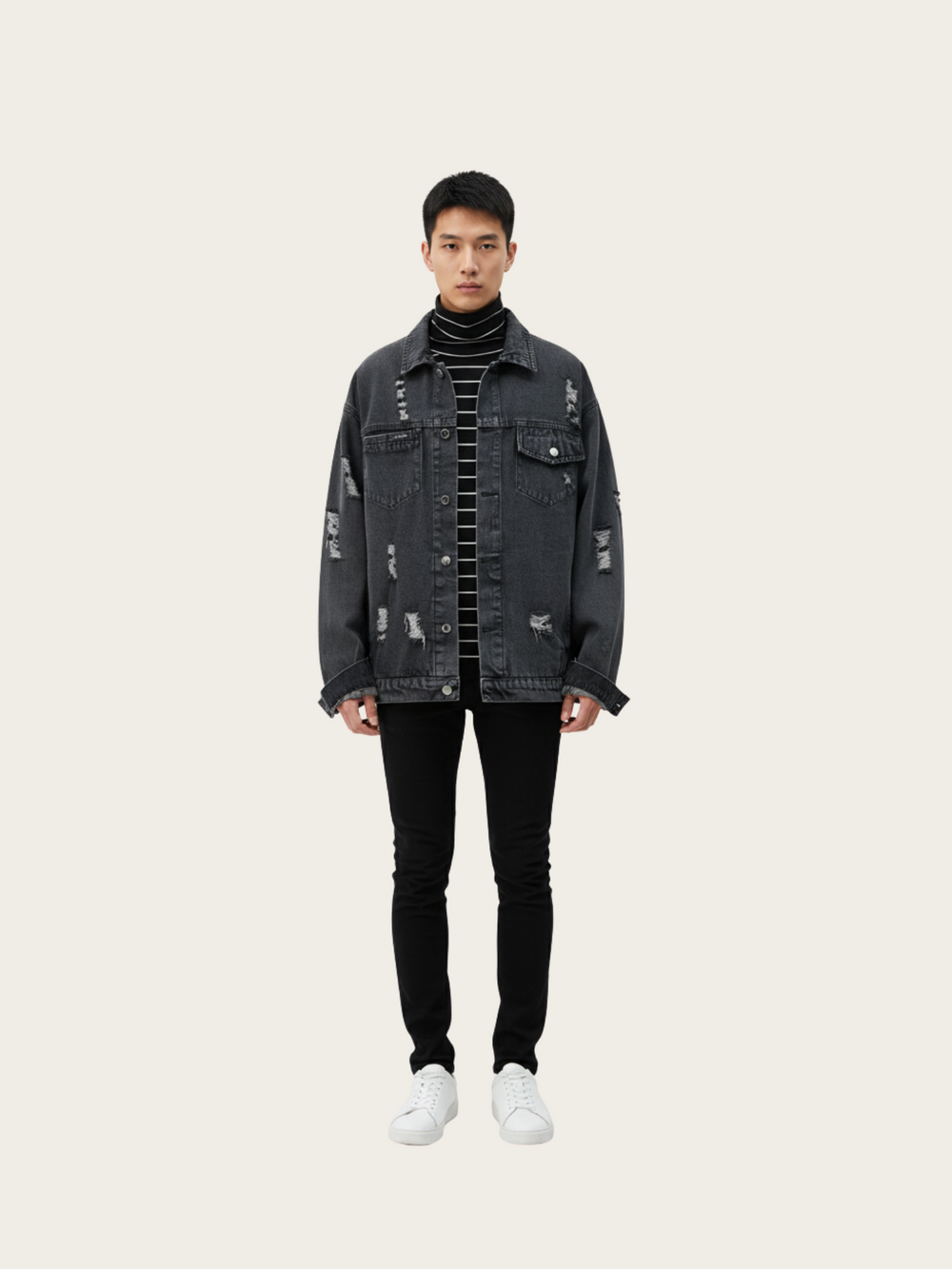 Man wearing a black distressed denim jacket on a white background