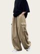 Person wearing beige cargo pants and a black top on a white background