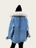 Blue denim jacket with white fur lining on a plain background