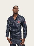 Man wearing a dark blue jacket with patches on a light beige background