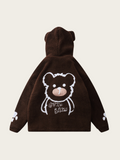 Brown hoodie with bear design on the back against a beige background
