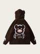 Brown hoodie with bear design on the back against a beige background