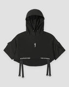 Black cropped hooded poncho top with ring straps at the hem, front view