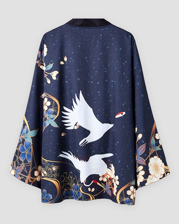 Dark navy haori jacket on a hanger, back view with two white cranes above a gold ring and blue and cream flowers at the hem