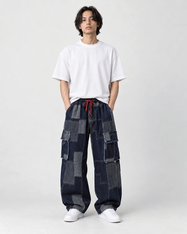 Model wearing the Patchwork Denim Cargo Pants with Raw-Edge Flap Pockets, front view