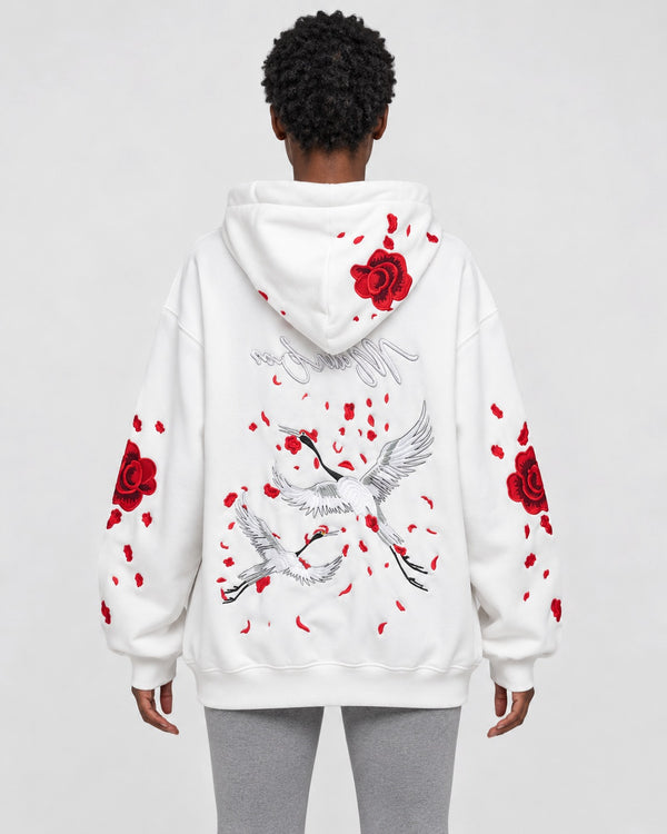 Model wearing the Women's Embroidered Rose and Crane Hoodie in white, front view