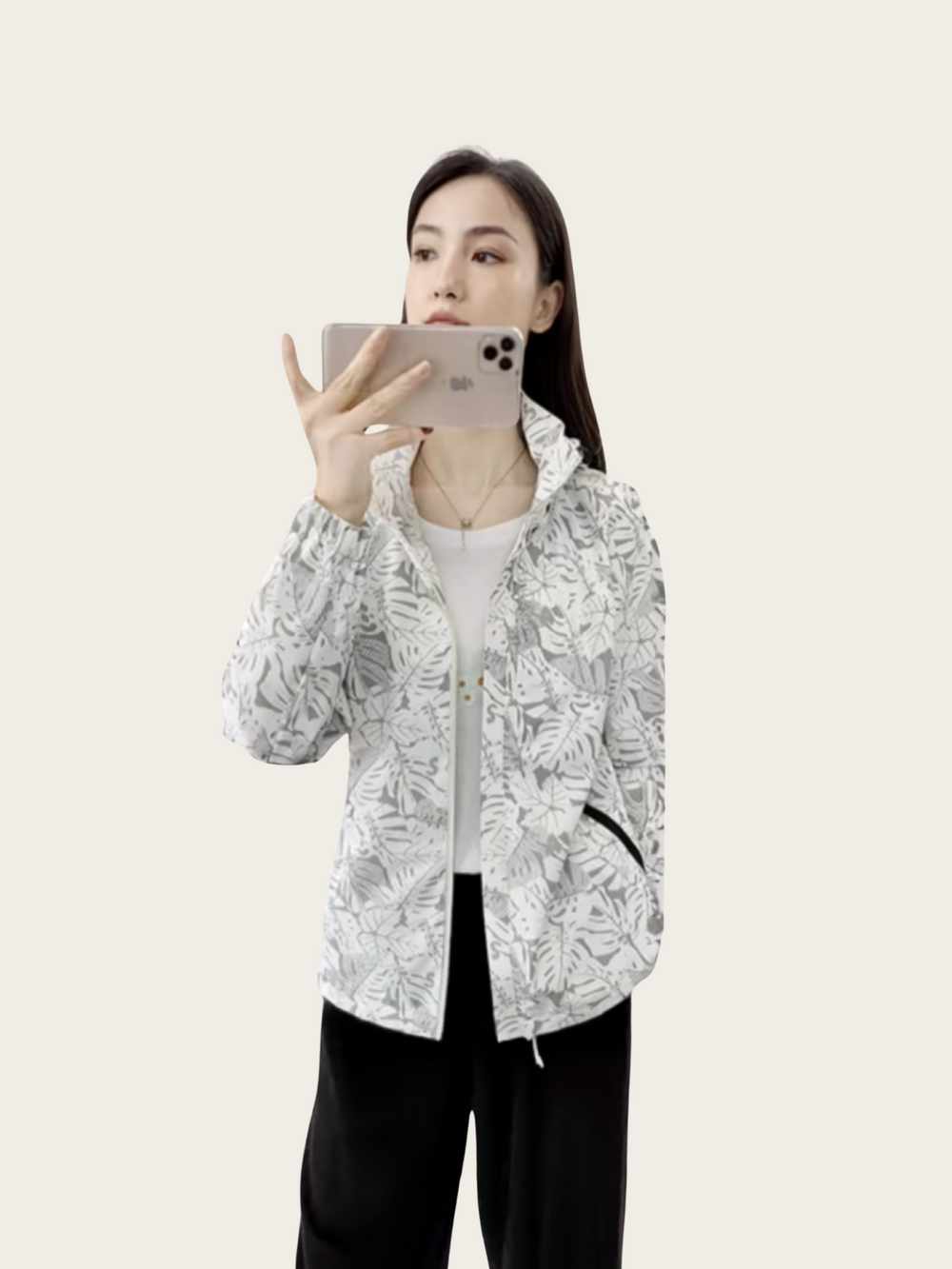 Person wearing a white floral jacket on a plain background