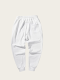 White sweatpants on a light beige background
