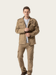 Man wearing a beige jacket and pants on a white background