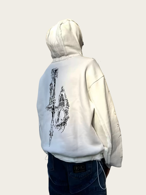 Person wearing a white hoodie with a black design on the back against a plain background