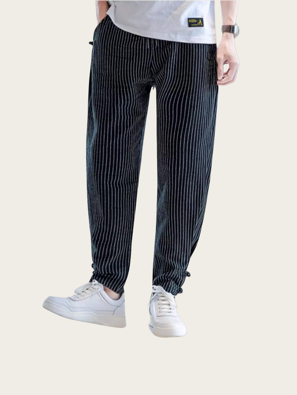 Person wearing black and white striped pants on a white background