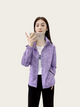 Woman wearing a purple jacket taking a selfie on a white background