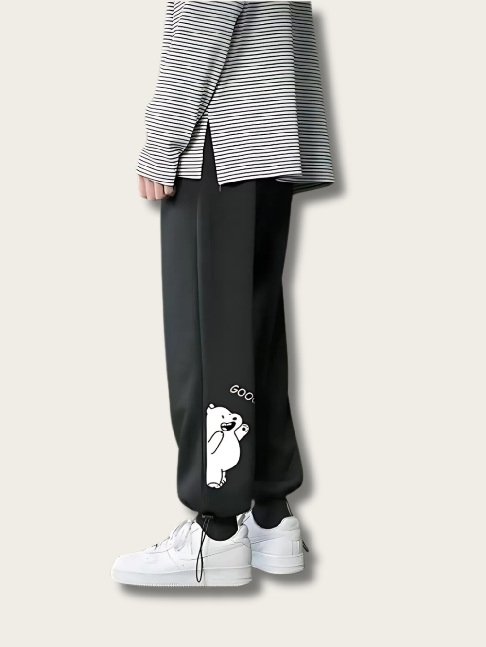 Black jogger pants with a white bear graphic and 'Goo' text worn by a person on a light gray background.