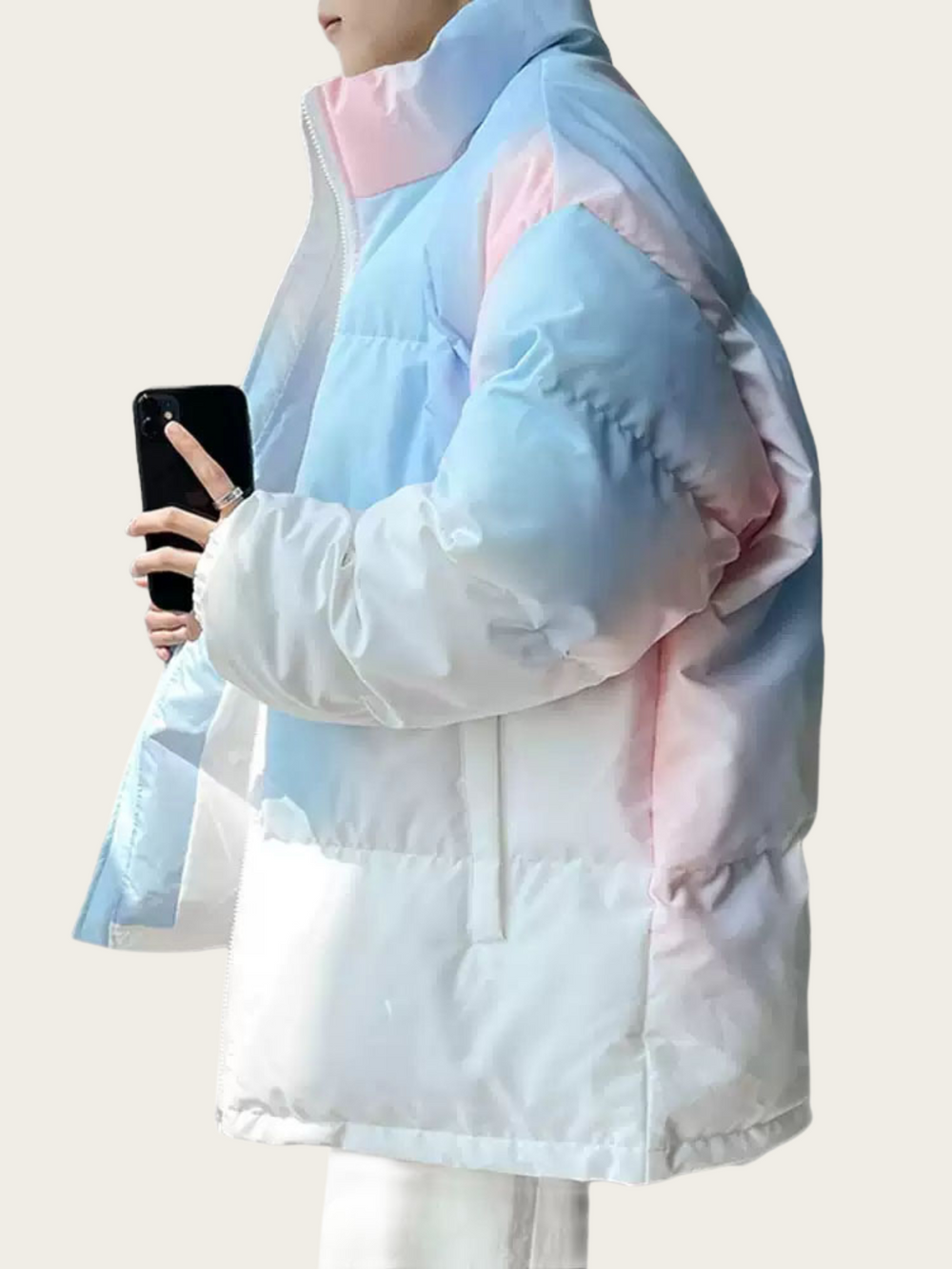 Person wearing a pastel-colored jacket with pink and blue tones on a white background