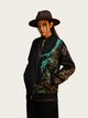 Person wearing a black jacket with floral patterns and a brown hat on a white background
