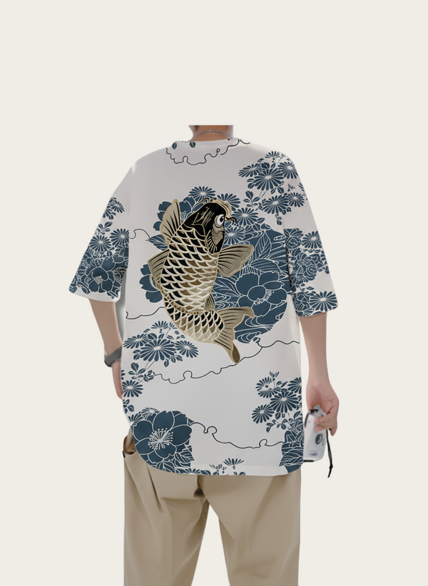 Person wearing a traditional-style shirt with fish and floral patterns on a plain background