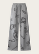 Gray sweatpants with black cartoon designs on a white background