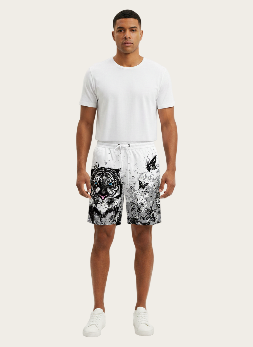 Man wearing a white t-shirt and black and white patterned shorts on a white background