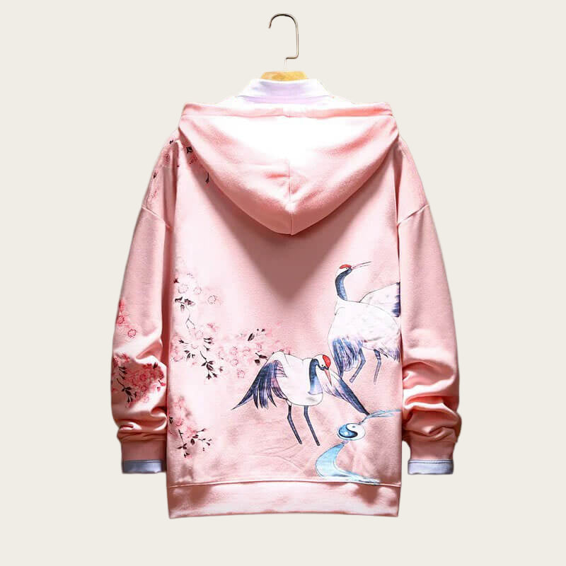 Pink hoodie with crane and cherry blossom design on a white background