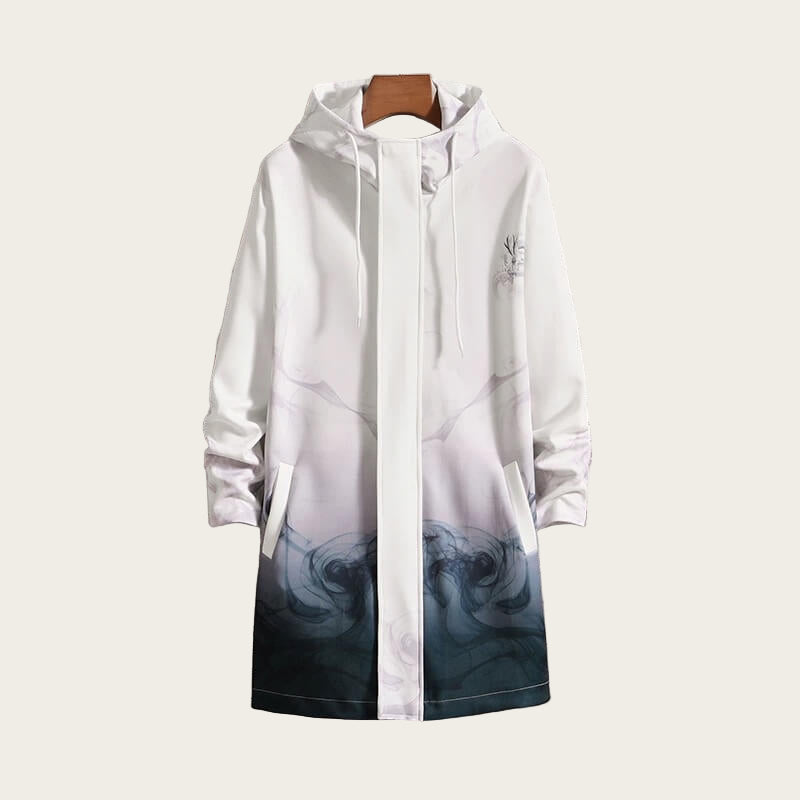 White raincoat with gradient design on a hanger against a stone wall background