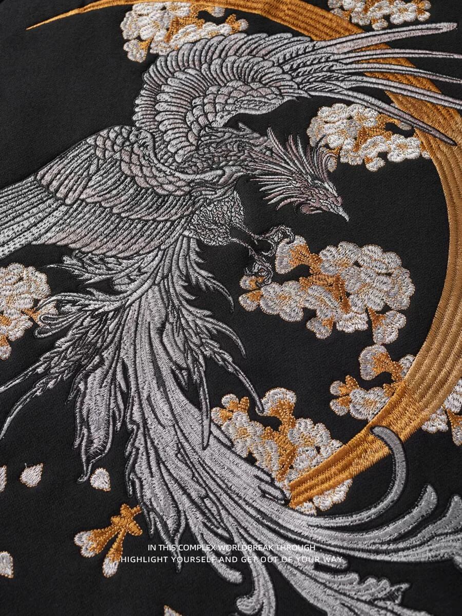 Embroidered design of a phoenix with floral elements on a black background