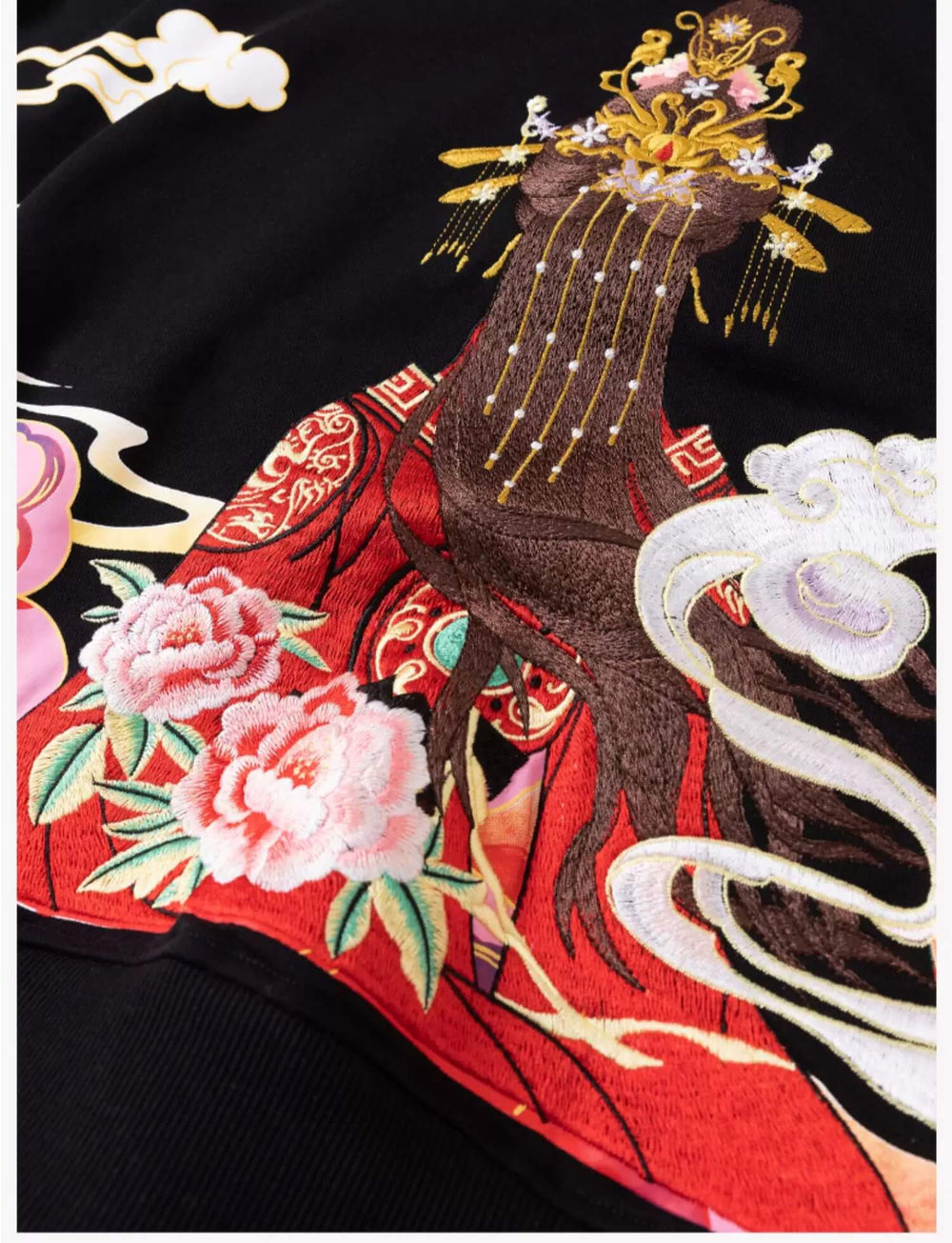 Embroidered fabric with traditional design featuring a phoenix, flowers, and clouds on a black background.