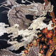 Embroidered dragon design on fabric with floral elements