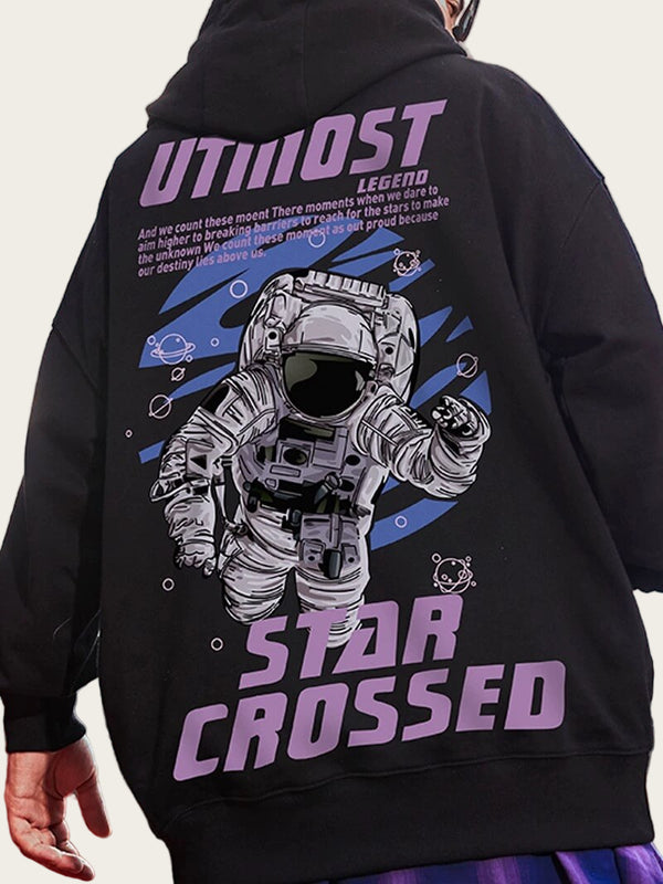 Black hoodie with astronaut graphic and 'Star Crossed' text on the back, against a blurred outdoor background.