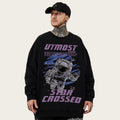 Person wearing a black sweatshirt with an astronaut graphic and 'UTMOST' text on a gray background