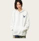 Person wearing a white hoodie with a logo in an outdoor setting