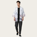Man wearing a floral kimono over a black shirt and pants