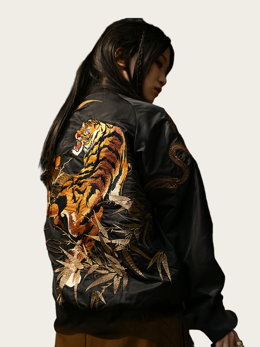 Black leather jacket with a tiger design on the back, worn by a person.