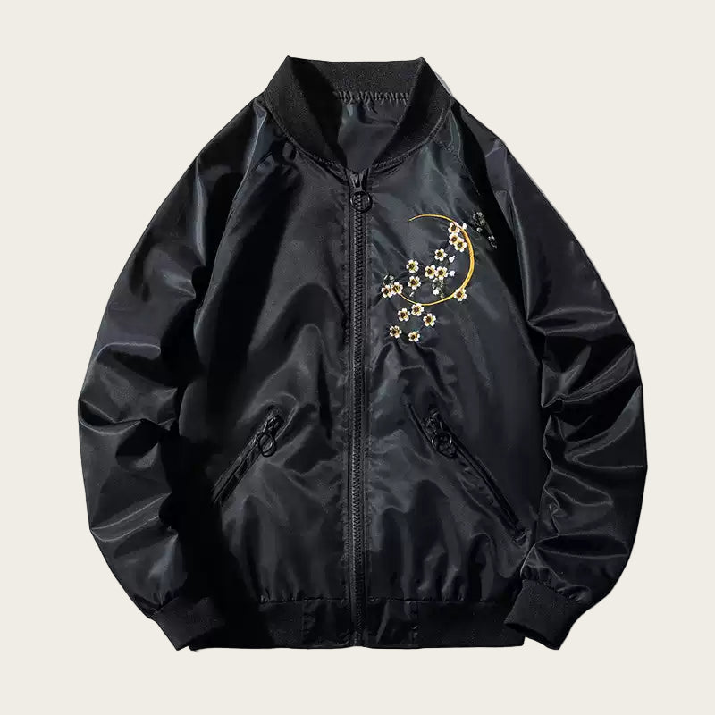 Black bomber jacket with floral embroidery on a white background