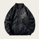 Black bomber jacket with floral embroidery on a white background