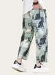 Pants with cat pattern and text worn by a person on a neutral background