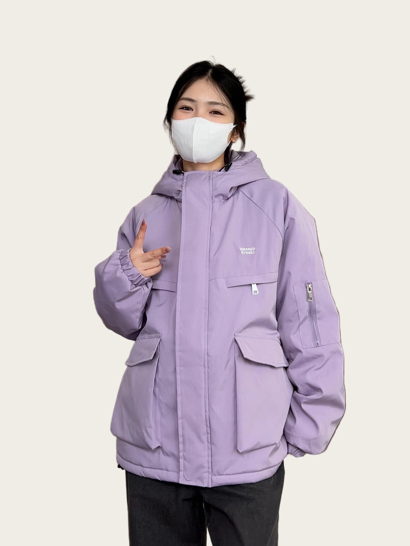 Person wearing a purple jacket indoors