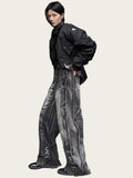 Person wearing a black jacket and gray pants